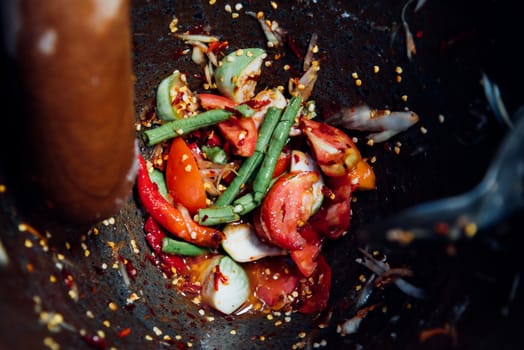 Papaya salad or Papaya Pok Pok (Som tum) for sale at Thai street food market or restaurant in Thailand