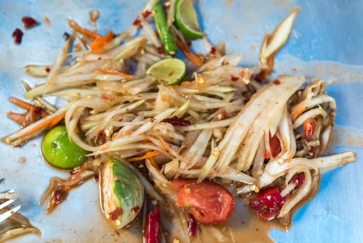 Papaya salad or Papaya Pok Pok (Som tum) for sale at Thai street food market or restaurant in Thailand