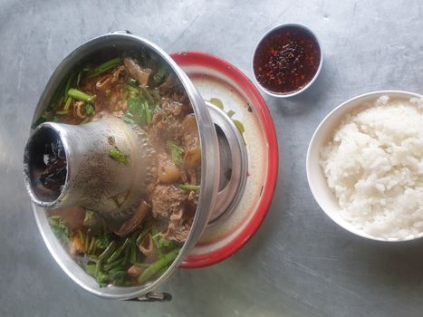 Braised beef clear with meat tendon soup stew (Ekaehla meat) with vegetable in hot pot for sale at Thai street food market or restaurant in Thailand