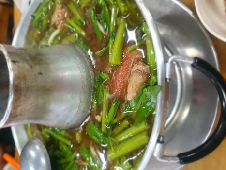 Braised beef clear with meat tendon soup stew (Ekaehla meat) with vegetable in hot pot for sale at Thai street food market or restaurant in Thailand