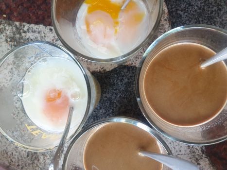 Breakfast food with soft-boiled eggs and vintage coffee Thai style for sale at Thai street food market or Thai vintage style coffee shop restaurant in Thailand