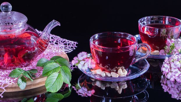 Tea time: cup of tea. Creative layout made of cup of hibiscus tea and leafs. Red tea, carcade, karkade, rooibos. Oriental, cozy, ceremony, tradition, japanese, leafy, hygge, autumn, 5 o'clock