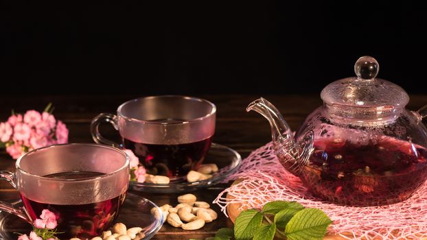 Creative layout made of cup of red tea and leafs. Tea time: cup of tea, carcade, karkade, rooibos. Oriental, cozy, ceremony, tradition, japanese, leafy, hygge, autumn, 5 o'clock, afternoon tea