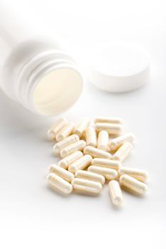 Yoghurt capsules isolated on a white background. Yoghurt Capsules aid in maintaining a normal healthy gastrointestinal system and digestive function.