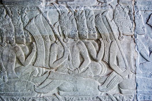 Kneeling demi-god soldiers in the Ramayana Hindu epic. Bas relief carving at Angkor Wat temple, Siem Reap, Cambodia.