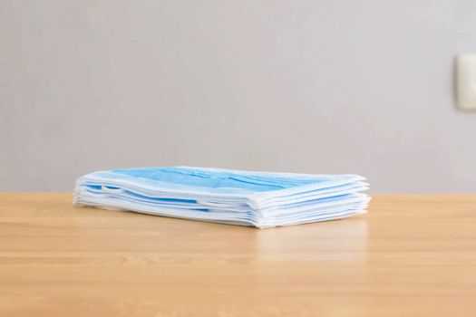 A pack of medical masks on the table. Personal protective equipment.