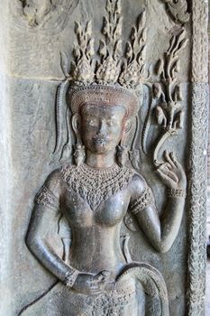 Ancient Khmer carving of an Apsara dancer goddess. Temple of Angkor Wat, Siem Reap, Cambodia.