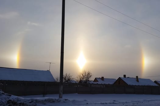 The phenomenon of halo in the sky. A rare natural phenomenon. Three halo suns.