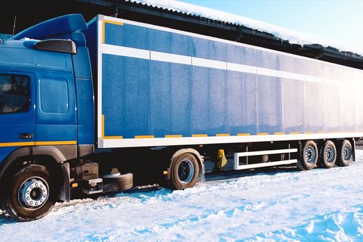 A large lorry with a trailer wagon. Cargo transportation in a container on a truck.