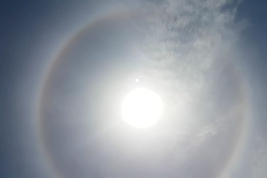 The phenomenon of halo in the sky. A rare natural phenomenon. Three halo suns.