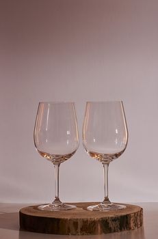 Two glasses of wine on white background, warm tone, wooden stump