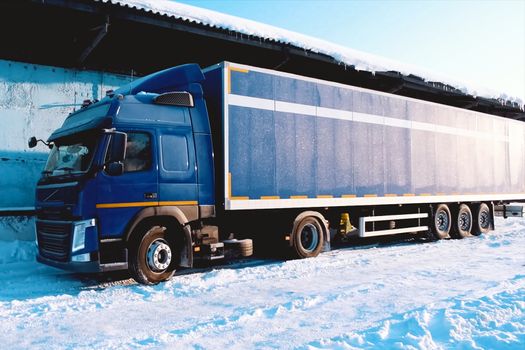 A large lorry with a trailer wagon. Cargo transportation in a container on a truck.