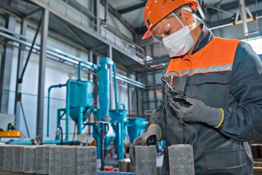 Moscow, Russia - January 10, 2020: A worker measures the thickness of the couplings of pumping oil pipes.