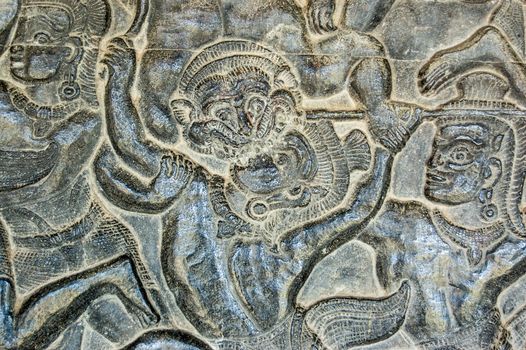 Ancient Khmer bas relief frieze showing a monkey soldier from the army of the Hindu god Hanuman attacking an enemy. Depiction of the Battle of Lanka on an inner wall of Angkor Wat temple, Cambodia.