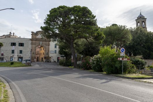 san gemini, italy june 13 2020: entrance door to the village on the right the public gardens that lead to the hill