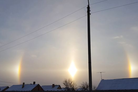 The phenomenon of halo in the sky. A rare natural phenomenon. Three halo suns.