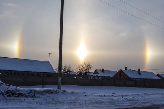 The phenomenon of halo in the sky. A rare natural phenomenon. Three halo suns.