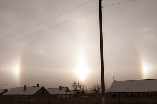 The phenomenon of halo in the sky. A rare natural phenomenon. Three halo suns.