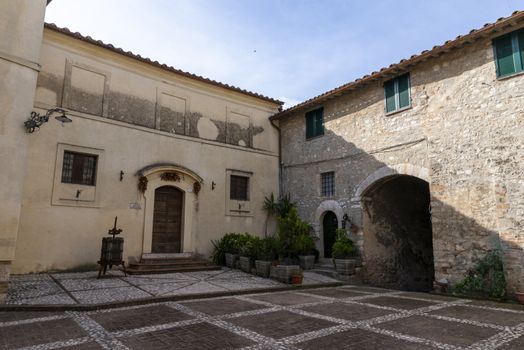 san gemini, italy june 13 2020: atrium inside the village with church and medieval youth hostel