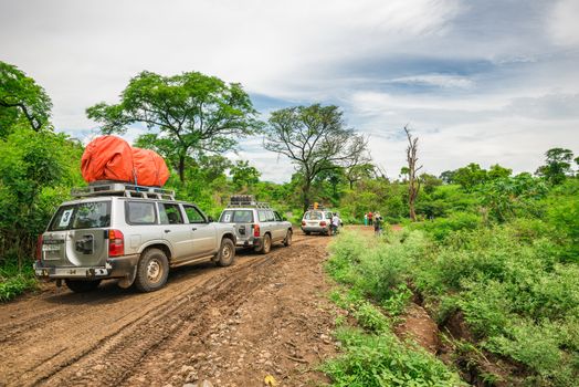 OMO VALLEY, ETHIOPIA - MAY 3, 2015 : SUV cars on an expedition in the rainforest of southern Ethiopia