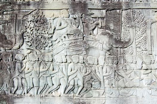 Ancient Khmer bas relief carving of an army commander riding an Elephant into battle. Outer wall of Bayon Temple, Angkor Thom, Siem Reap, Cambodia.