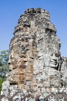 Serene faces carved on the ancient Khmer temple of Bayon, Angkor Thom, Siem Reap, Cambodia.