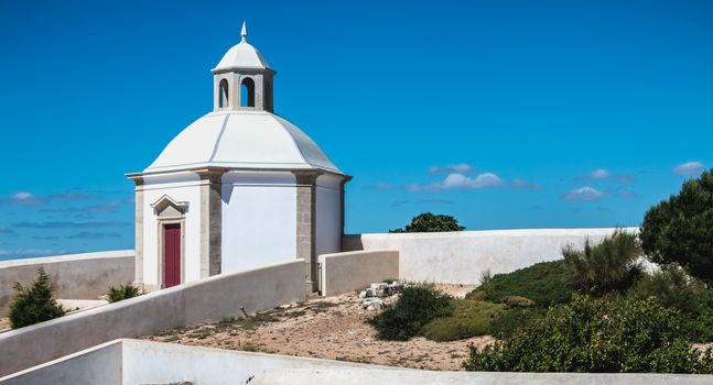 Cape Espichel near Sesimbra, Portugal - August 8, 2018: Architectural detail of the Cape Espichel sanctuary on a summer day. The Baroque church is built between 1701 and 1707 in memory of the Holy Mary in 1410