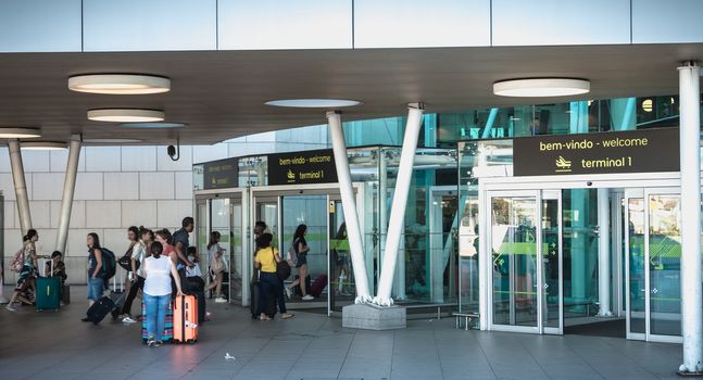 Lisbon, Portugal - August 7, 2018: exterior view of Lisbon International Airport where travelers walk on a summer day