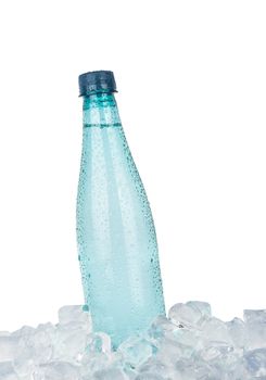 One full PET plastic bottle of cold still drinking water chilling on ice cubes isolated on white background, low angle side view