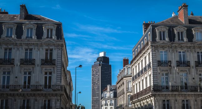 Nantes, France - September 25, 2018: Typical building architecture detail in historic downtown where people walk on a summer day