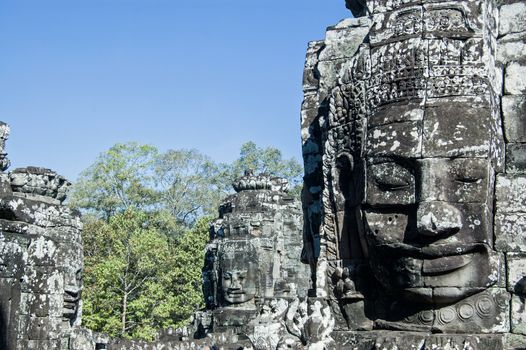 View at the top of Bayon Temple, Cambodia of the faces carved onto the towers of this ancient Khmer monument. Angkor Thom, Siem Reap, Cambodia.
