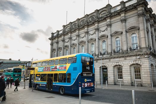 Dublin, Ireland - February 13, 2019: Double decker Irish bus that parks in front of Heuston train station in the city center on a winter day