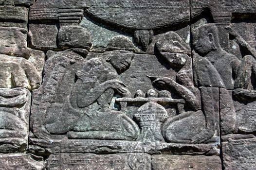 Ancient Khmer bas relief frieze showing two men playing chess. Wall of Bayon Temple, Angkor Thom, Siem Reap, Cambodia.