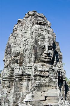 Serene faces carved on the ancient Khmer temple of Bayon, Angkor Thom, Siem Reap, Cambodia.