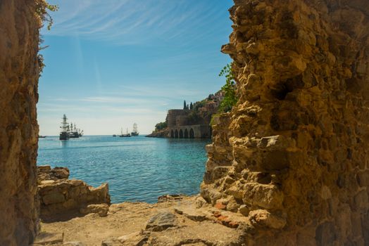 Shipyard Tersane, Alanya historical dockyard. The building with arches on the inside. Ships sailing on the sea. Alanya peninsula, Antalya district, Turkey, Asia