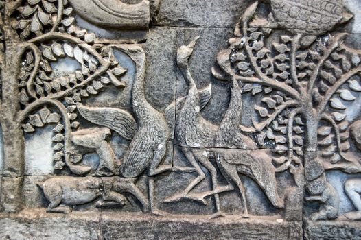 Ancient bas relief carving of three geese dancing. Wall of the Khmer Bayon Temple, Angkor Thom, Siem Reap, Cambodia