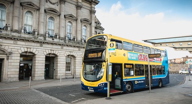Dublin, Ireland - February 13, 2019: Double decker Irish bus that parks in front of Heuston train station in the city center on a winter day