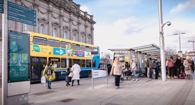 Dublin, Ireland - February 13, 2019: Double decker Irish bus that parks in front of Heuston train station in the city center on a winter day