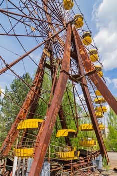 Old broken rusty metal radioactive electric wheel abandoned, the park of culture and recreation in the city of Pripyat, the Chernobyl disaster, Ukraine.