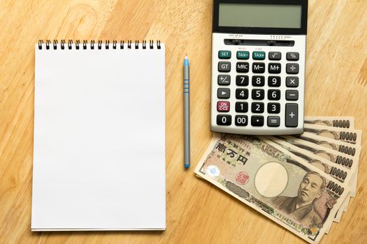 White note book place on wooden table background