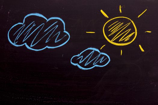Chalk drawing as yellow sun and blue cloud background