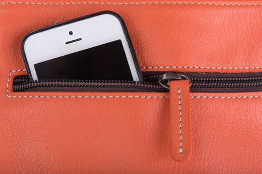 Mobile phone in orange leather pocket