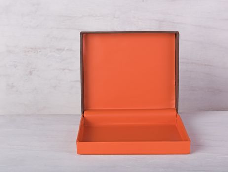 Orange gift box on grunge wood background