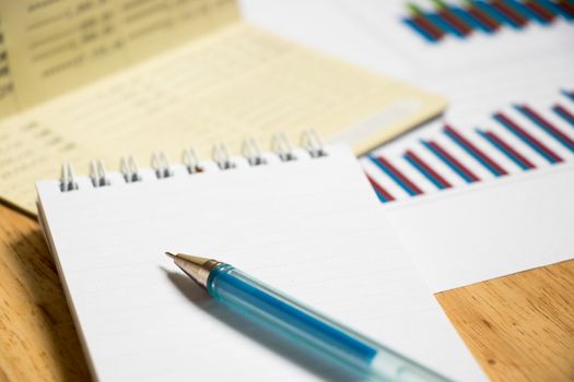 Background of passbook, note book with pen and financial graph