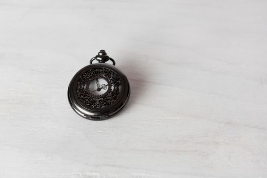 Classic pocket watch on white grune wooden background 