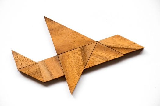 Wooden tangram puzzle in airplane shape on white background (Concept for new experience, start project)