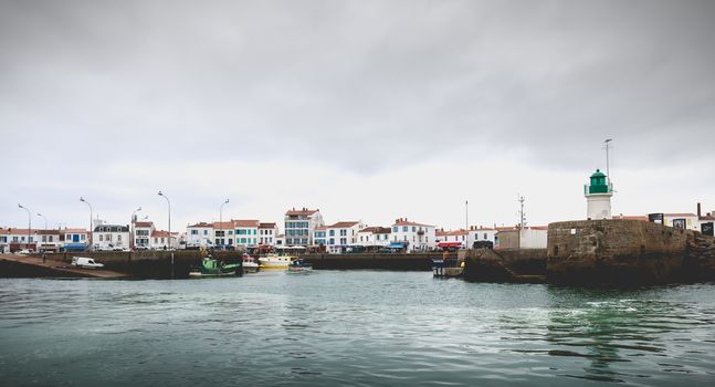 Port Joinville on the island of Yeu - September 18, 2018: entrance to the port of the island of Yeu with its semaphore and typical small houses on a fall day