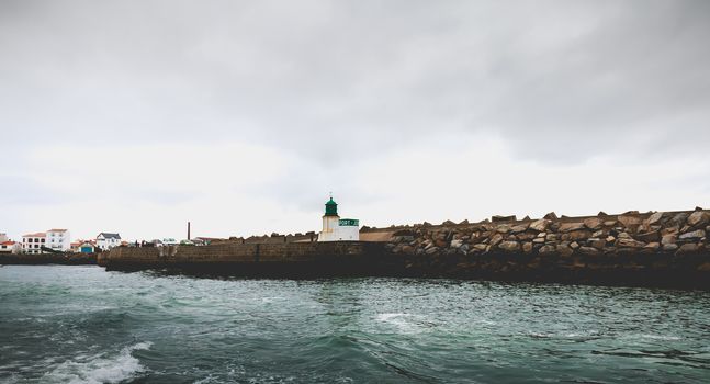 Port Joinville on the island of Yeu - September 18, 2018: entrance to the port of the island of Yeu with its semaphore and typical small houses on a fall day