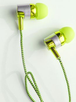 Yellow headphones on a white background close-up, vertical photo.