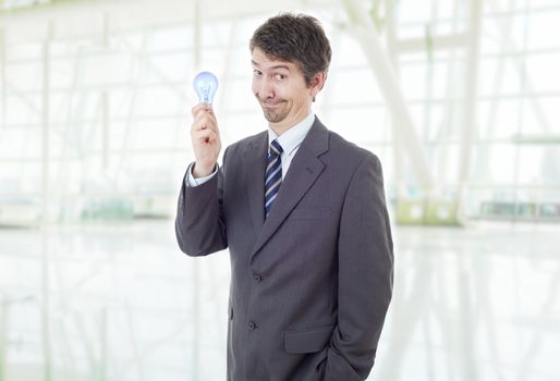 silly business man with a lamp at the office